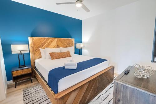 a bedroom with a bed with a blue wall at The Rambler Inn in Arlington