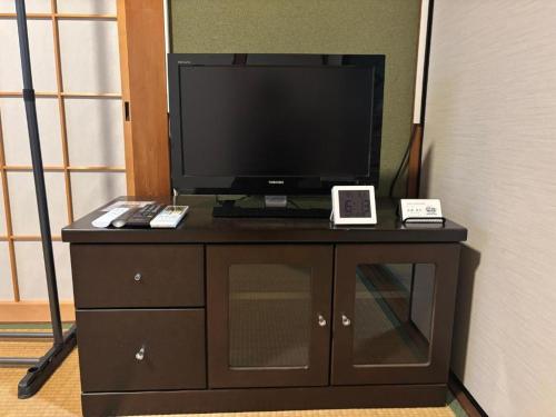 a tv sitting on top of a dresser at kyoto next door in Otsu