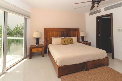 a bedroom with a bed and a large window at Luxury 3 Bedroom Condo - Beachfront Complex at Mareazul - Buena Vida in Playa del Carmen