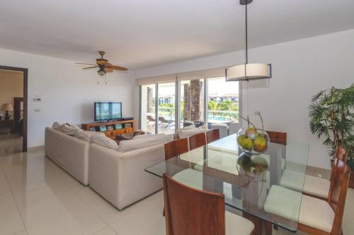a living room with a couch and a glass table at Luxury 3 Bedroom Condo - Beachfront Complex at Mareazul - Buena Vida in Playa del Carmen