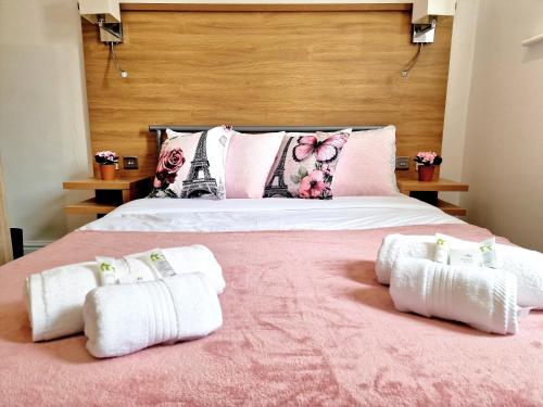a bedroom with a bed with towels on it at Sweet Rose Guest House Room 4 in Oxford