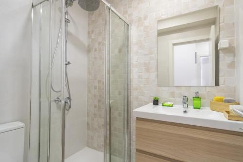 a bathroom with a glass shower and a sink at LV Premier Amoreiras AM3 in Lisbon