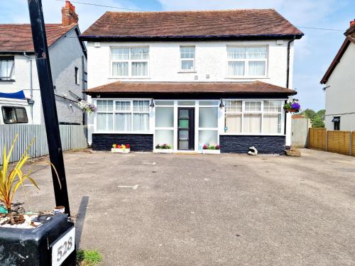 a white house with a driveway in front of it at Sweet Rose Guest House Room 4 in Oxford