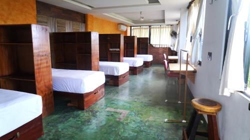 a row of bunk beds in a room at Madre Tierra Hostal in Puerto Escondido
