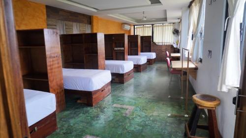 a row of bunk beds in a room at Madre Tierra Hostal in Puerto Escondido