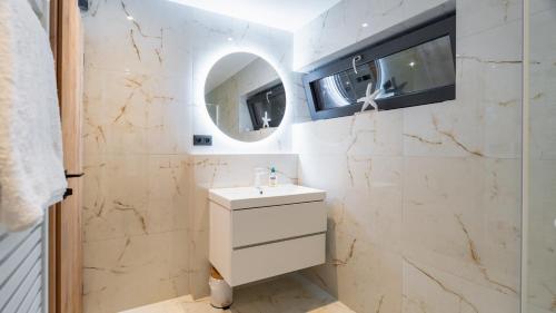 a bathroom with a sink and a mirror at Lipno - Luxury Lake Villa in Nové Domky