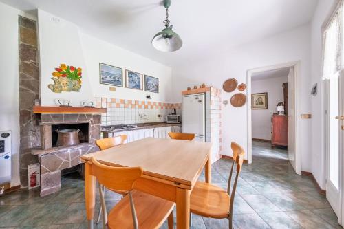 a kitchen with a wooden table and chairs at Villa Nonni in Acquaseria