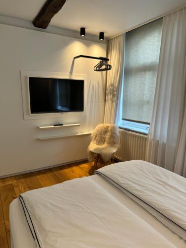 a bedroom with a bed and a flat screen tv at accademia00 in Maastricht