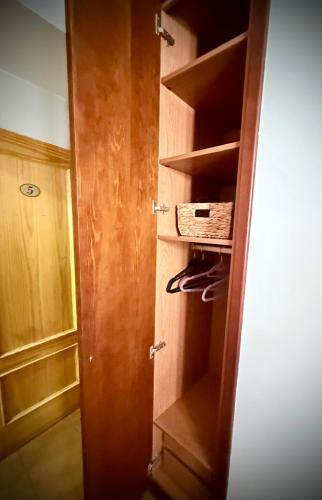 a closet with a wooden door and a drawer at Pensión San Pedro in Viana