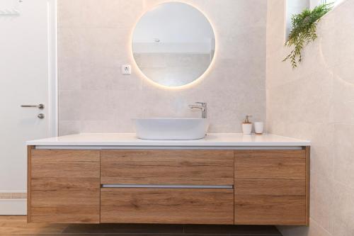 a bathroom with a sink and a mirror at House Tre Venti with pool in Sveti Filip i Jakov
