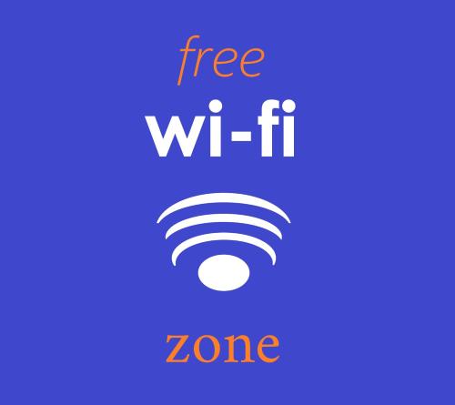 a sign that says free wi fi zone with a wifi symbol at Vista Mare in Mattinata