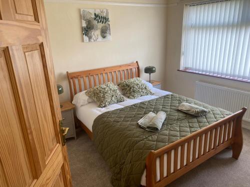a bedroom with a large bed with pillows on it at Prospect Beach House 1, Portstewart in Portstewart