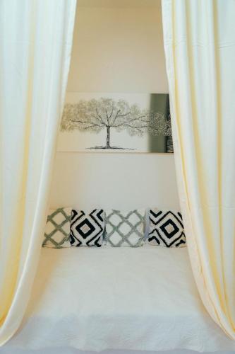 a bed with a tree picture on the wall at Apartman Suada in Fojnica