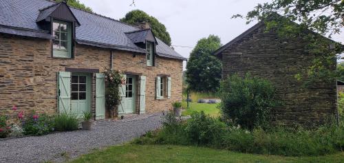 a brick house with green doors and a yard at La Villauvert - Cottage in Saint-Martin-sur-Oust
