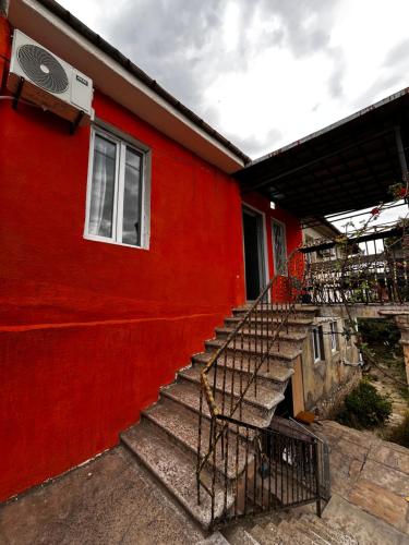 a red building with stairs and a window at old kutaisi in Kutaisi