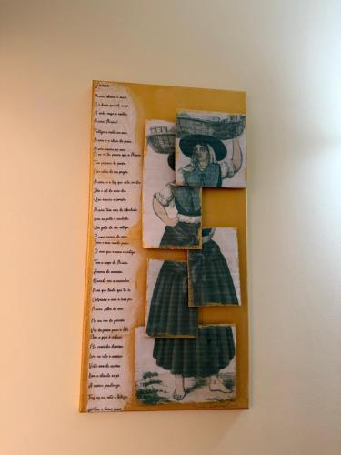 a picture of a woman in a dress on a book at Casa da vala in Praia de Mira
