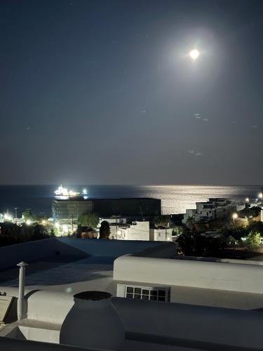 a view of the ocean at night from a building at Galini Bungalows in Kionia