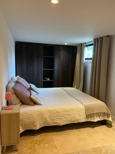 une chambre avec un grand lit avec des oreillers dessus dans l'établissement Maison Martens Villa & Appartement, à Lorgues