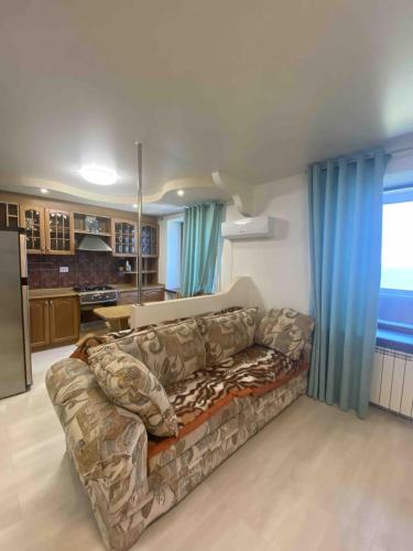 un salon avec un canapé et une cuisine dans l'établissement Квартира с видом на море, à Tchornomorsk