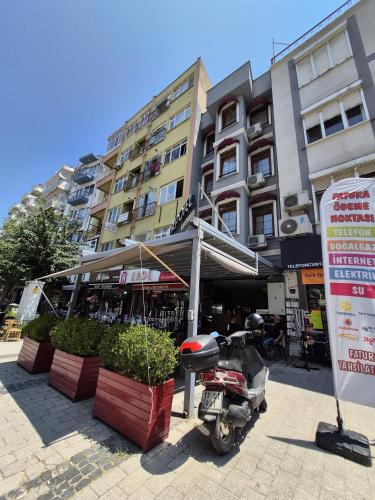 a motorcycle parked in front of a building at Mangır Otel in Canakkale