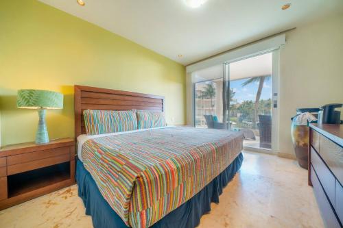 Un dormitorio con una cama y una ventana grande en Ocean View Condo - 2 Bedrooms - at The Elements Condos - Castillo de Arena, en Playa del Carmen