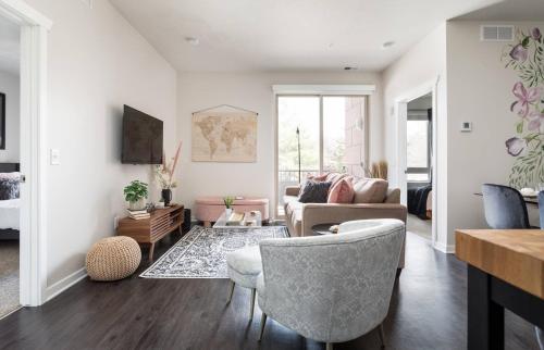 a living room with a couch and a chair at TC Sweet Pea - 2-Bedroom Condo Near Downtown TC! in Traverse City