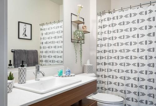 a bathroom with a sink and a toilet at TC Sweet Pea - 2-Bedroom Condo Near Downtown TC! in Traverse City
