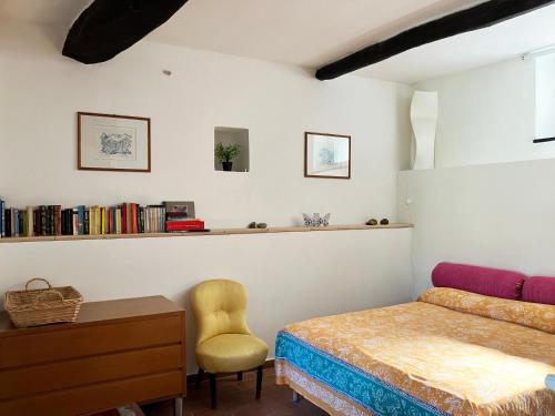 a bedroom with a bed and a desk and a chair at La Casetta della Pietra in Montale
