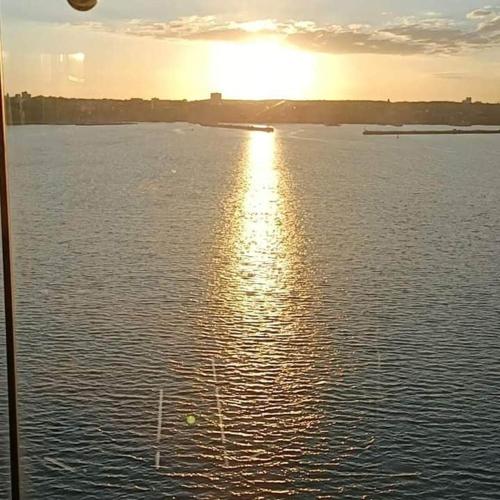 a view of a large body of water with the sun setting at Casa Patrizia in Acquaviva Picena