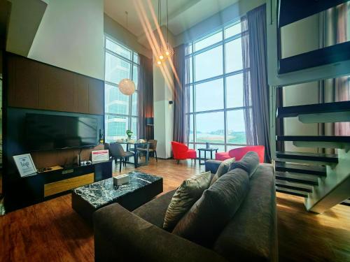 a living room with a couch and a television at Maritime Suite by Ocean Luxe 2BR Seaview Dryer Water Dispenser in George Town