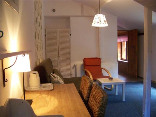 a living room with a couch and a table at Willa Avita in Karpacz