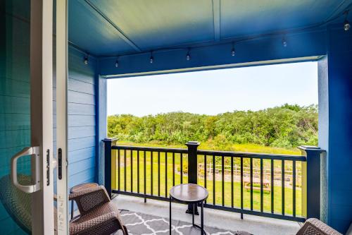 a balcony with a table and chairs and a large window at Walk to the Beach Ocean Shores Condo! in Ocean Shores