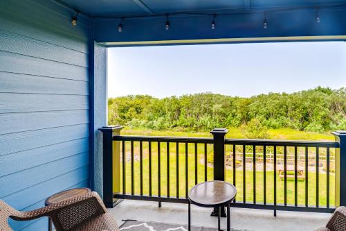 a balcony with a table and chairs on a blue house at Walk to the Beach Ocean Shores Condo! in Ocean Shores
