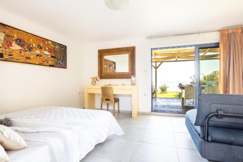 a bedroom with a bed and a desk and a chair at Nautilus house in Stalos