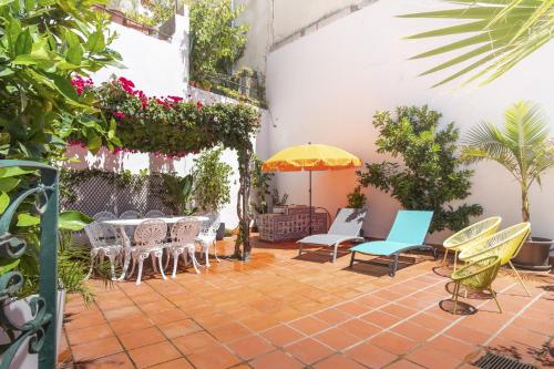 a patio with a table and chairs and an umbrella at LV Premier Bica River View in Lisbon