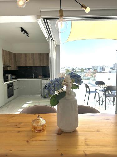 a vase of flowers sitting on a wooden table at Luxury City Penthouse-Panoramic View-Near Unic in Nicosia