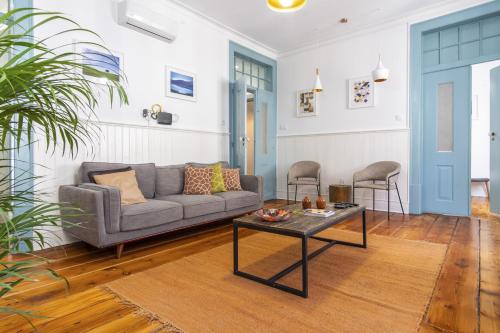 a living room with a couch and a table at LV Premier Baixa DO in Lisbon