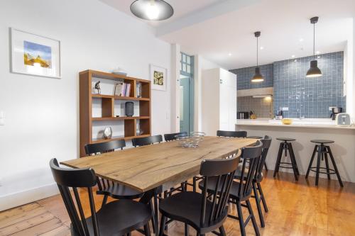 a dining room with a wooden table and chairs at LV Premier Baixa DO in Lisbon