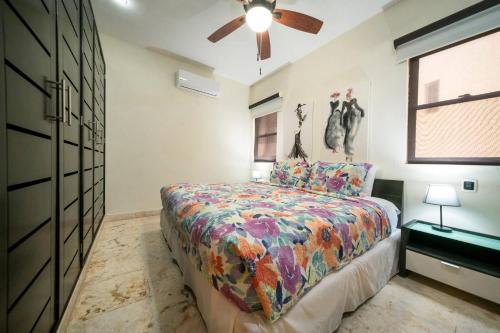 a bedroom with a bed and a ceiling fan at Condo Surf 301 - Luxury Oceanview Beachfront with Gym - At El Faro Condos in Playa del Carmen