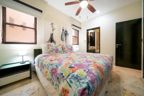a bedroom with a bed and a ceiling fan at Condo Surf 301 - Luxury Oceanview Beachfront with Gym - At El Faro Condos in Playa del Carmen
