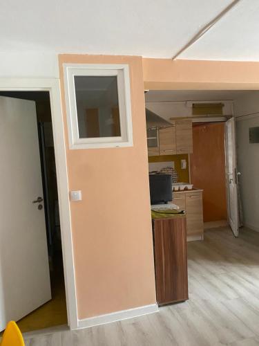 an empty room with a kitchen and a counter at Igoumenitsa heart flats to let Mariasroom studios appart seaside-city Spyropoulos in Igoumenitsa