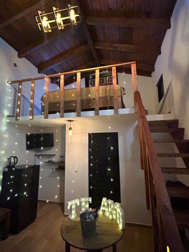 a room with a staircase and a table and a stair case at Cabañas La Victoria By GEstores in Huasca de Ocampo