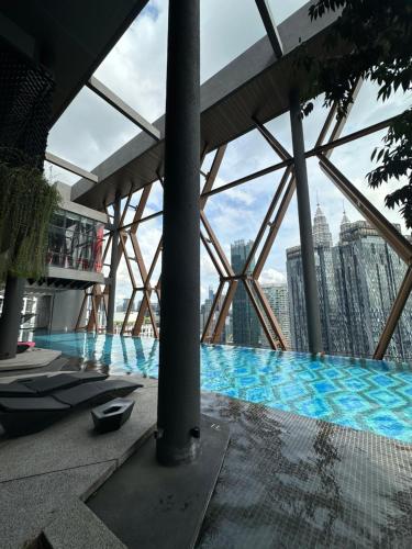 a view from the top of a building with a swimming pool at Scartlez suites KLCC by Dream in Gua Sai