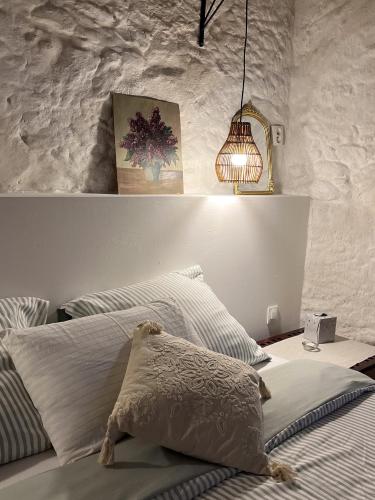 a bedroom with a bed with a pillow and a lamp at Écurie de l oasis in Caux