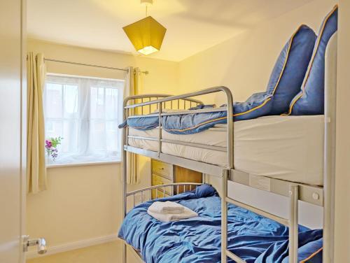 two bunk beds in a room with a window at Oysters in West Wittering