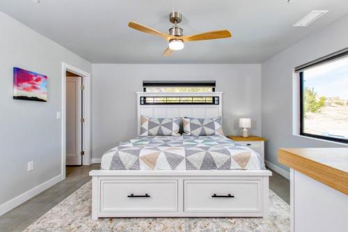 a bedroom with a bed with a ceiling fan at Soak at Boulder Cove in Yucca Valley