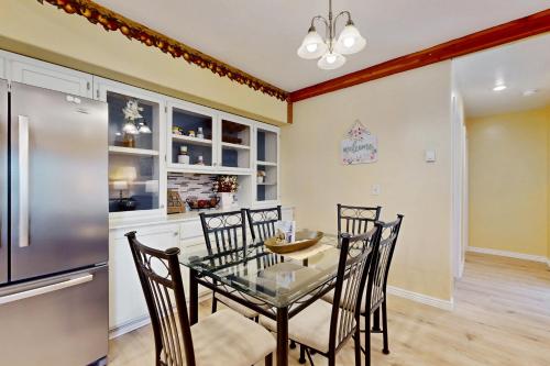 a dining room with a table and chairs and a refrigerator at Hungry Horse Hideout - Lower Level in Hungry Horse