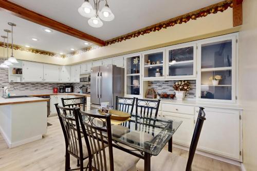 a kitchen with white cabinets and a table and chairs at Hungry Horse Hideout - Lower Level in Hungry Horse