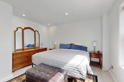 a bedroom with a bed and a mirror and a couch at Hungry Horse Hideout - Lower Level in Hungry Horse