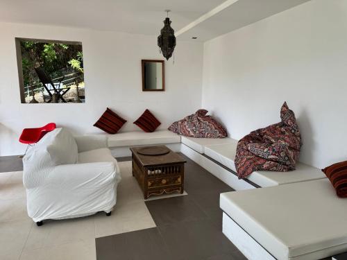 a living room with two white couches and a table at Villa Hirondelles 35 in Cavalaire-sur-Mer
